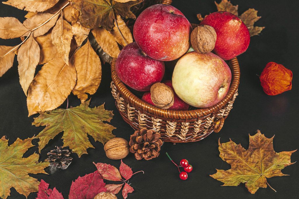 Thanksgiving autumn background with autumn leaves, nuts and apples
