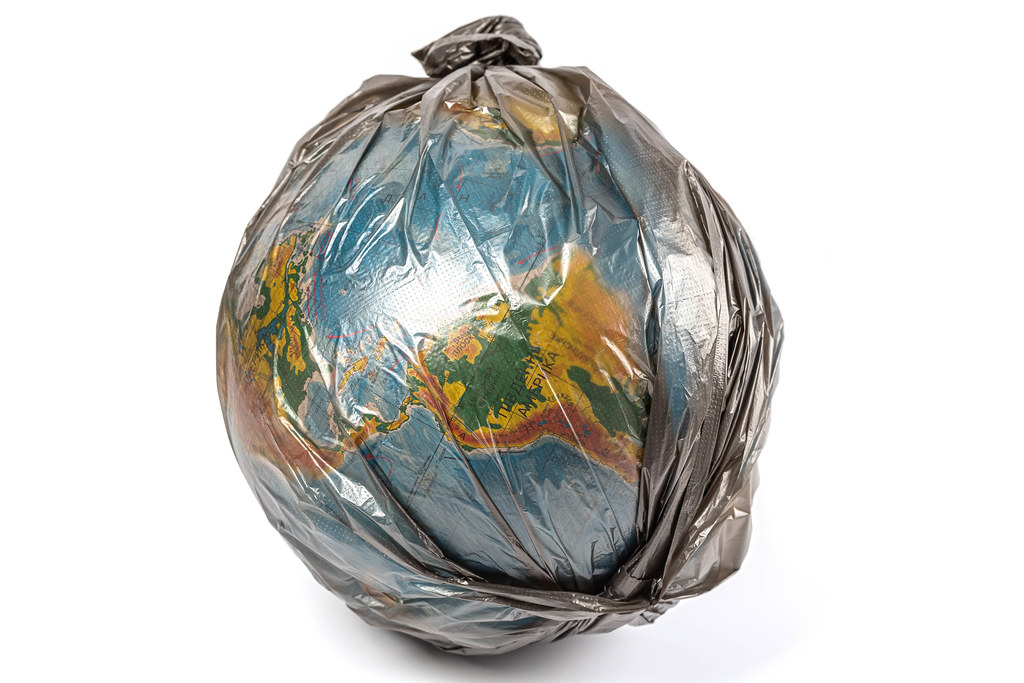 The globe in a black plastic bag, the concept of global pollution
