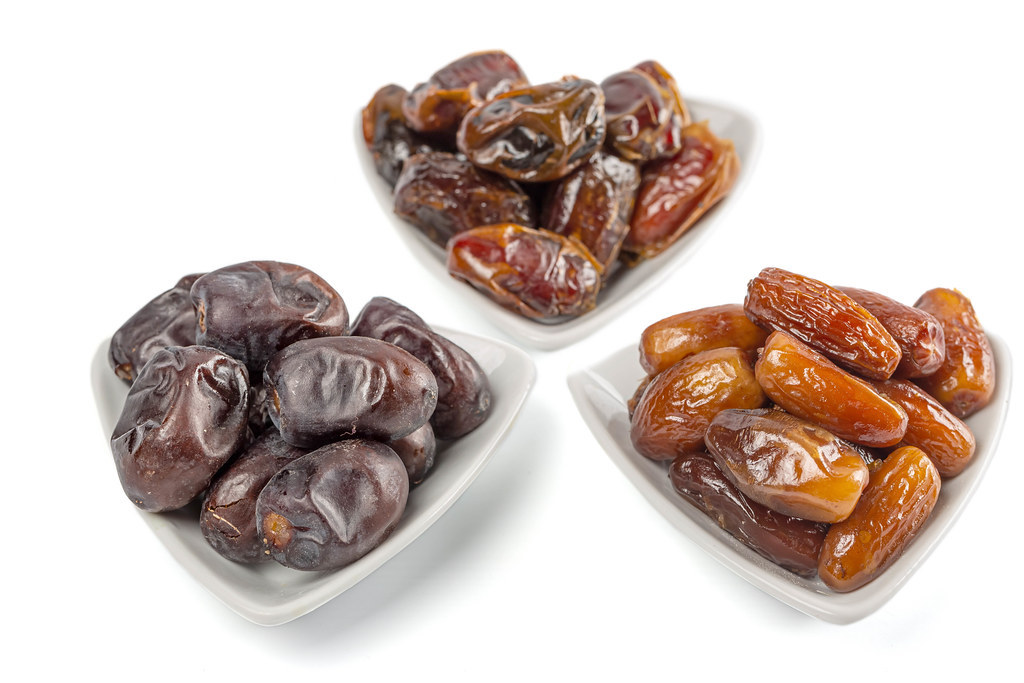 Three different kind of dried dates, fruits of date palm in white bowls