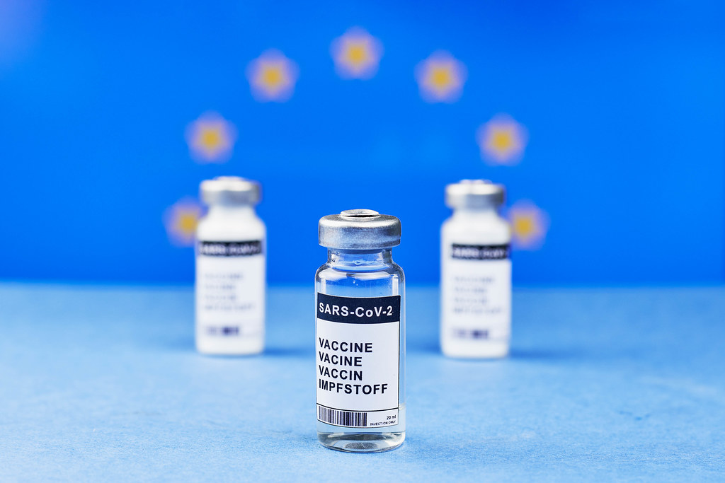 Three doses of SARS-CoV-2 vaccine against the European Union flag