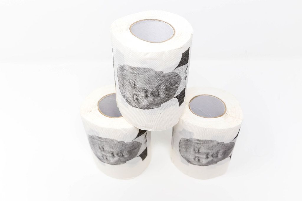 Three rolls of Donal Trump toilet paper with white background