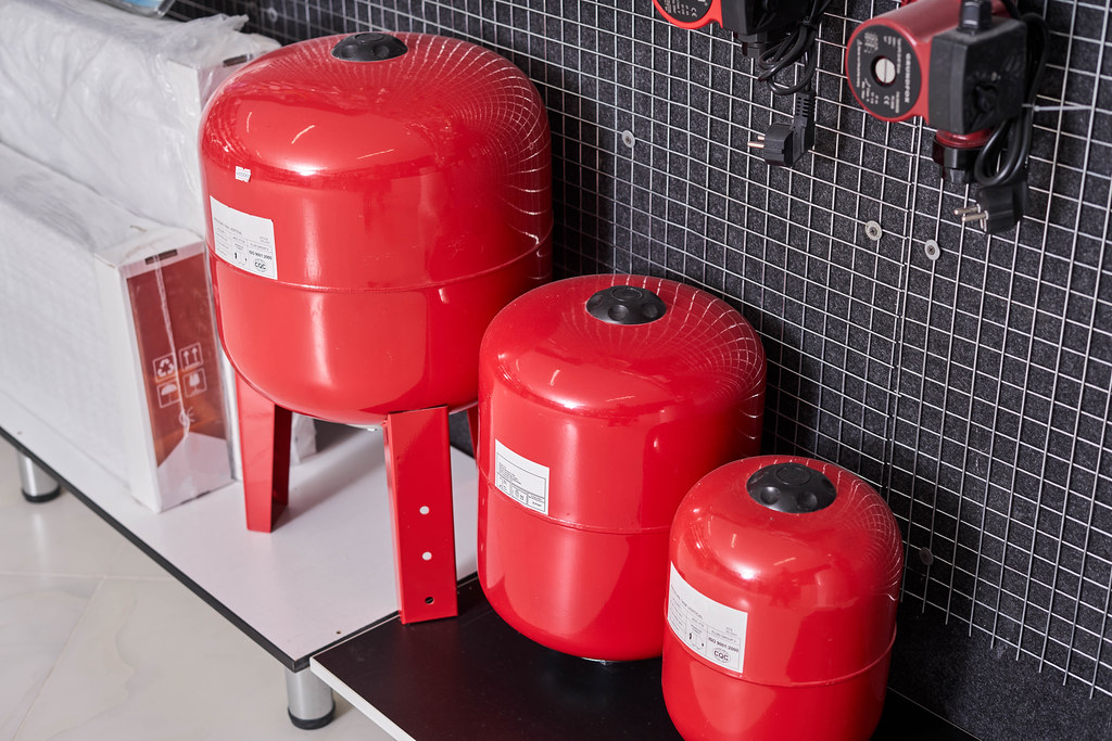 Three sizes of vertical gas pressure tanks in the construction store