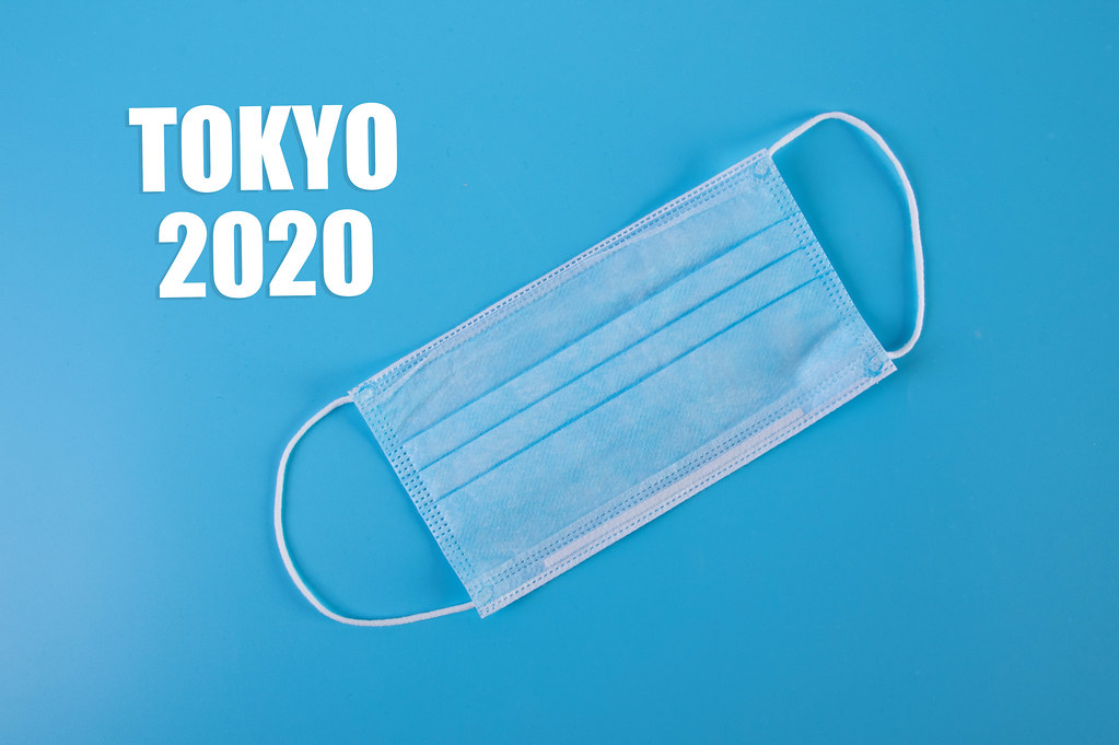 Tokyo 2020 text with medical face mask on blue background