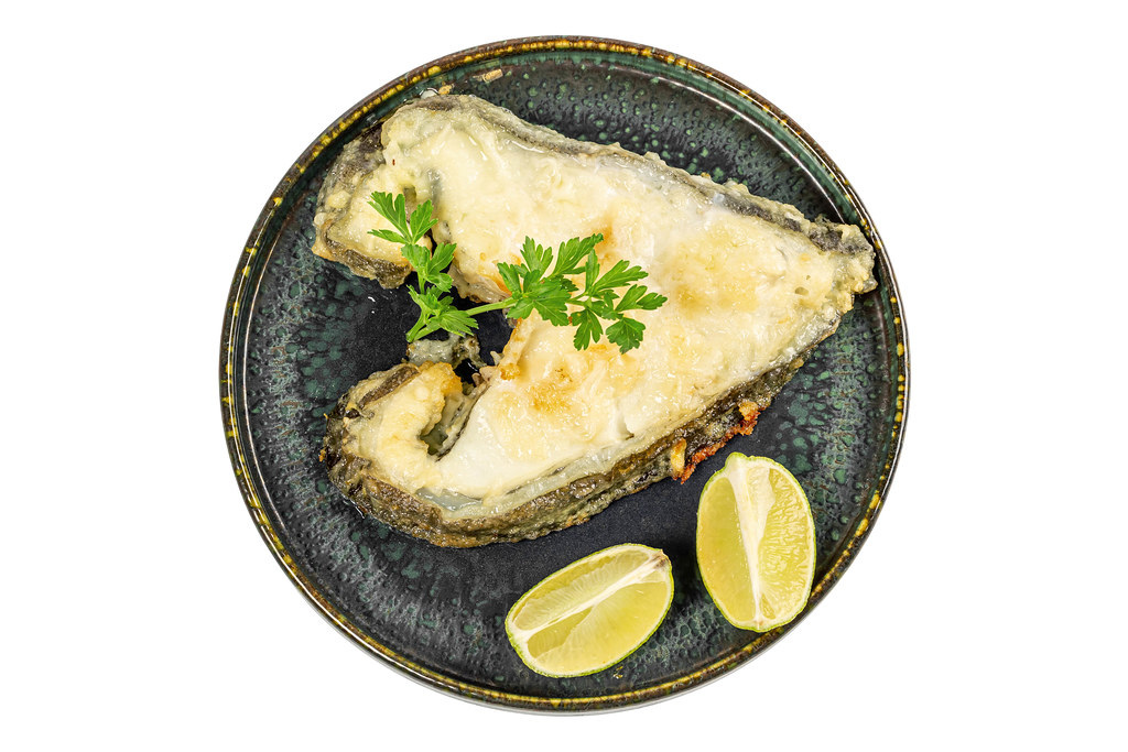 Top view, catfish steak with parsley and lime slices