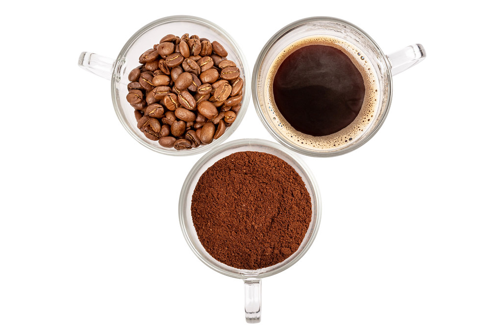 Top view, cups with made coffee, whole coffee beans and ground coffee