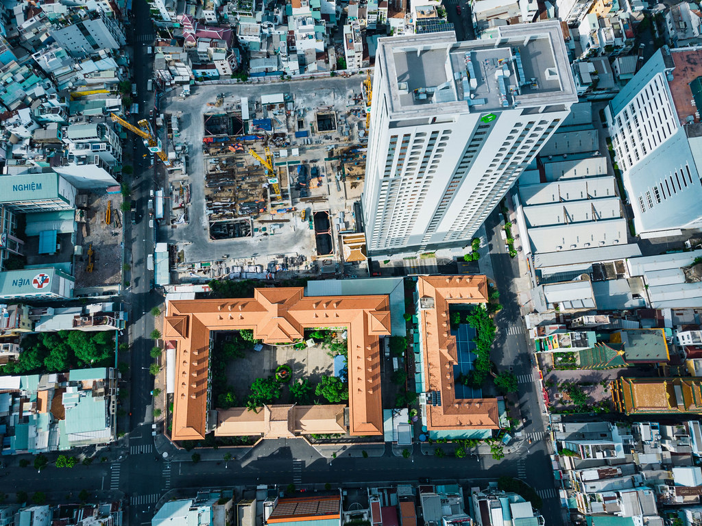 Top View Drone Photo of Luong The Vinh High School next to a large Apartment Building Construction Site in Ho Chi Minh City, Vietnam