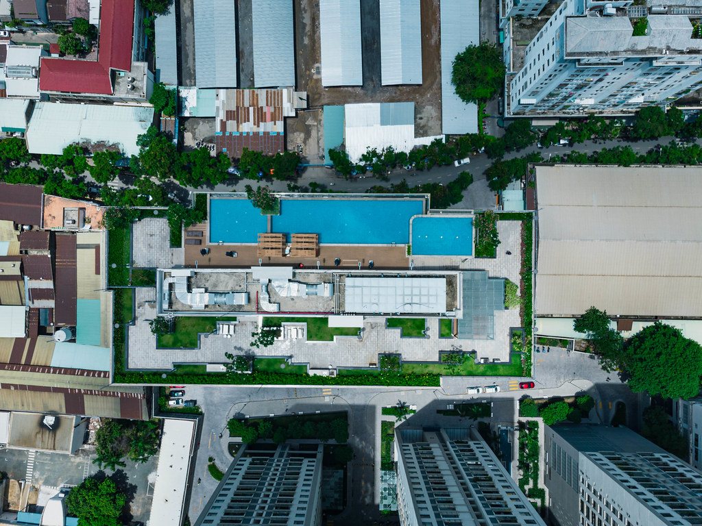 Top View Drone Photo of the Rooftop of GoldView Apartment Building with Small Garden and Swimming Pool in District 4 in Saigon, Vietnam
