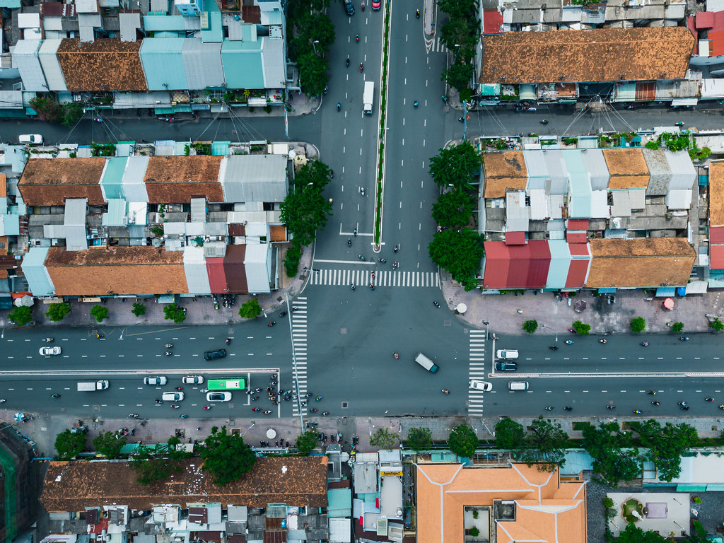 Top View Drone Photo of Traffic at a large Intersection, Buildings, Trees and Alleys in Ho Chi Minh City, Vietnam