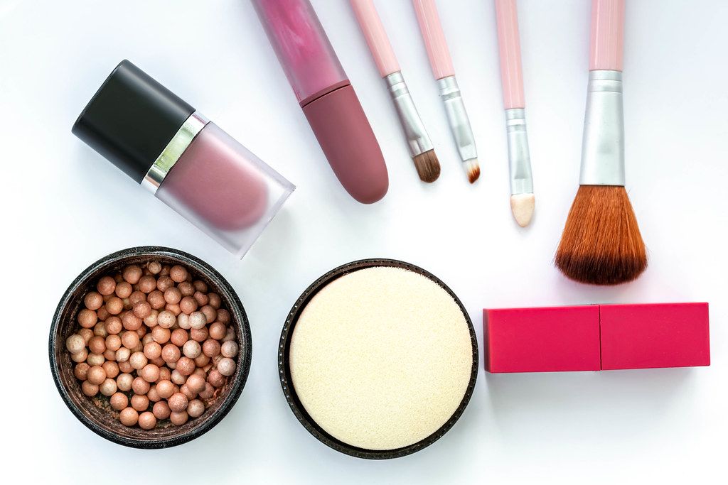 Top view, female cosmetics and brushes on a white background