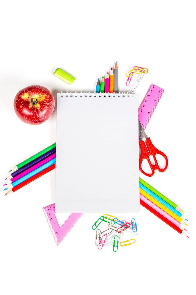Top view, frame from multicolored school supplies with blank notebook in the middle