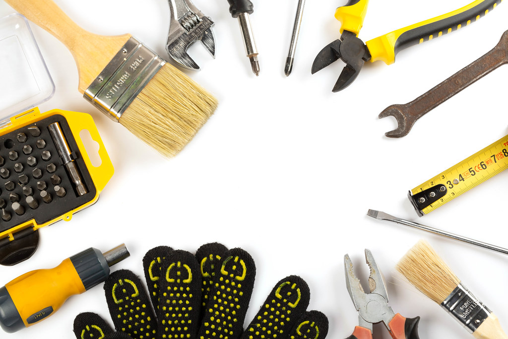 Top view, frame of work tools and gloves on a wooden background