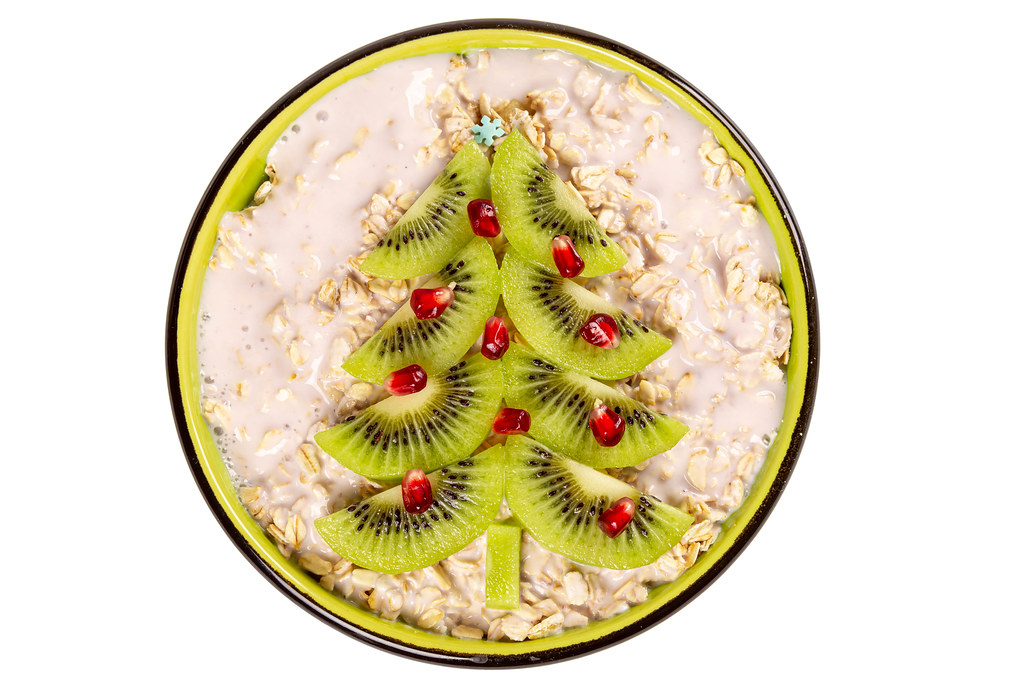 Top view, oatmeal decorated christmas tree made from kiwi slices
