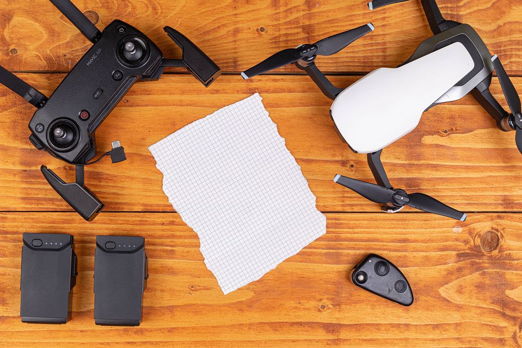 Top view of DJI Mavic Air drone with copy space on the blank white paper