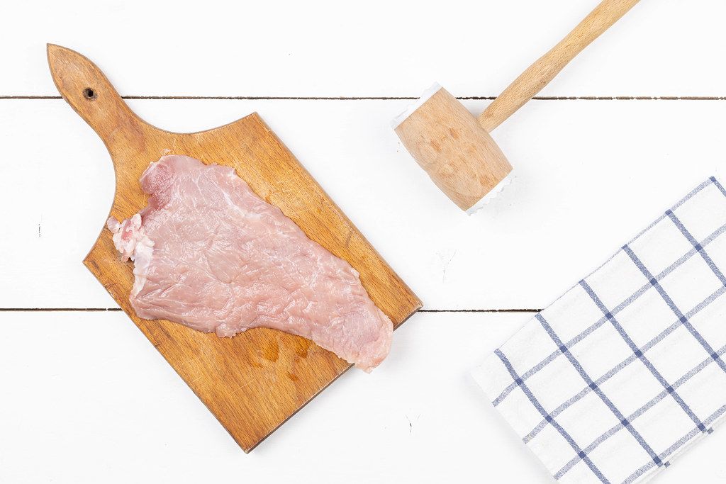 Top view of Pork Raw Meat with meat hammer