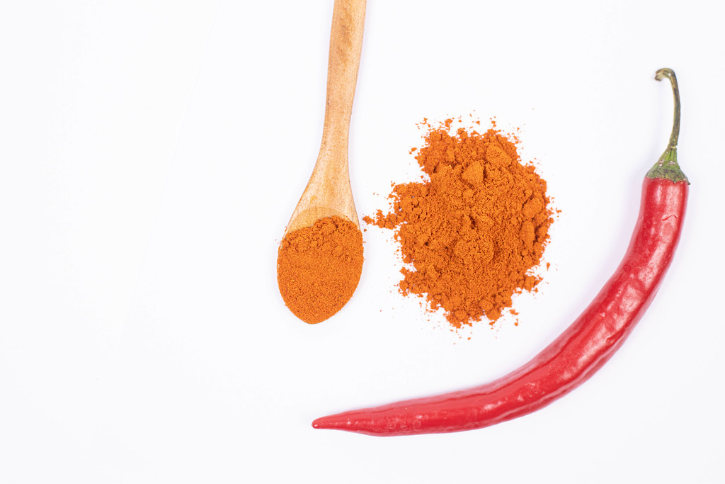 Top view of Red spicy Paprika powder on the white background