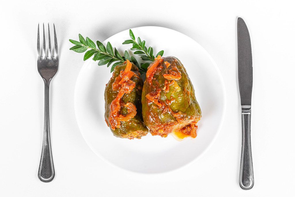 Top view, stuffed sweet peppers with tomato sauce