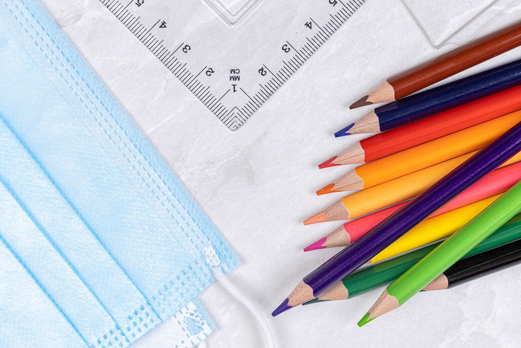 Top view Wooden Colorful pencils with Rulers and surgical masks for virus protection