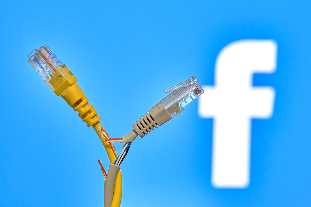 Torn connection cables over Facebook logo
