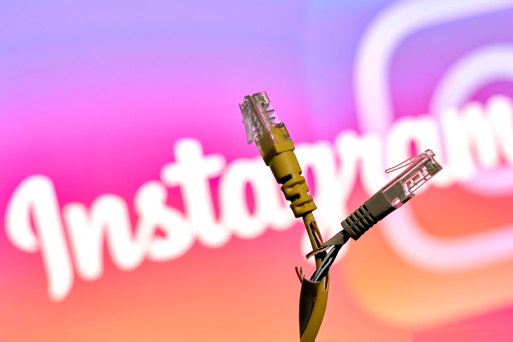 Torn internet connection cables and Instagram logo. Symbol of Instagram down