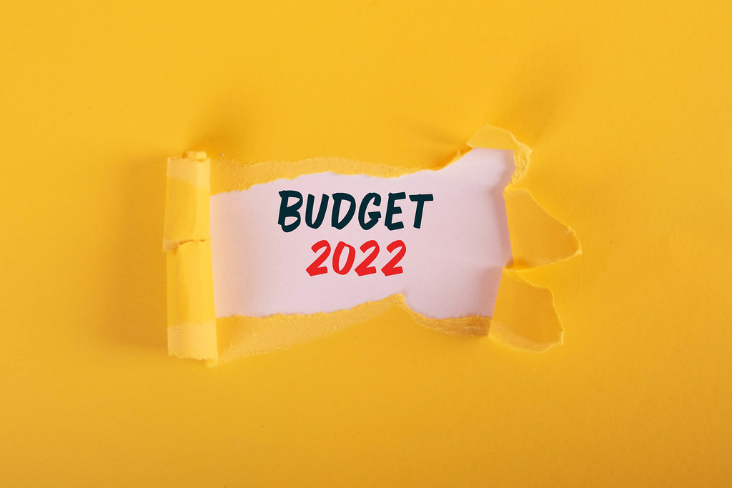 Torn paper revealing budget 2022 text