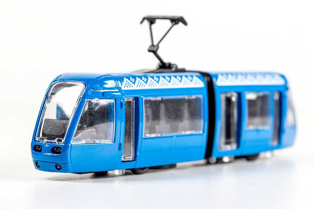 Toy blue tram on white background
