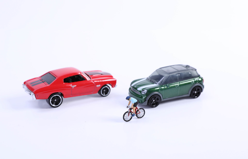 Toy cars and miniature cyclist