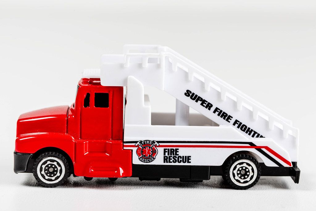 Toy plastic fire truck on white background