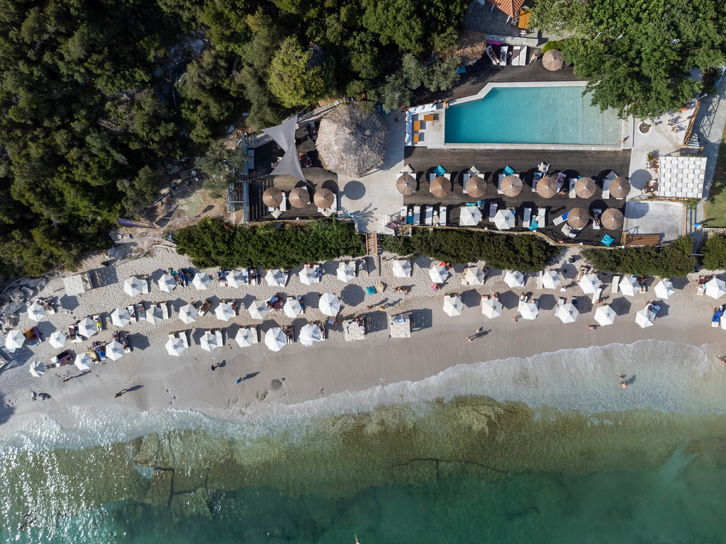 Tropical-style beach on Greek island Skopelos with crystal-clear waters and pool by the sea