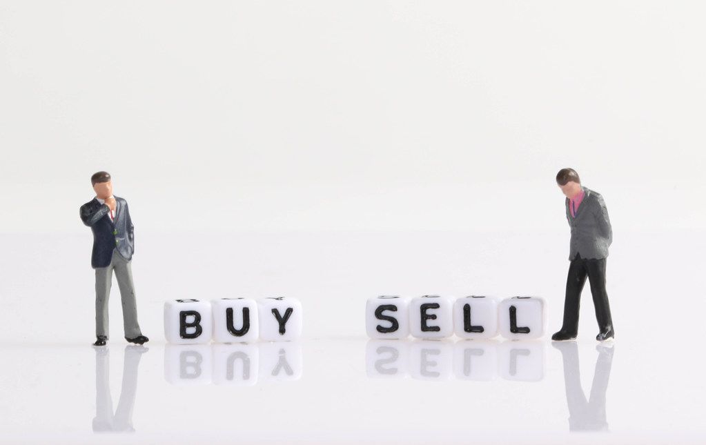 Two businessman with Buy and Sell text