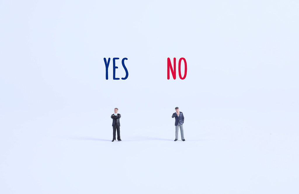 Two businessman with Yes and No text