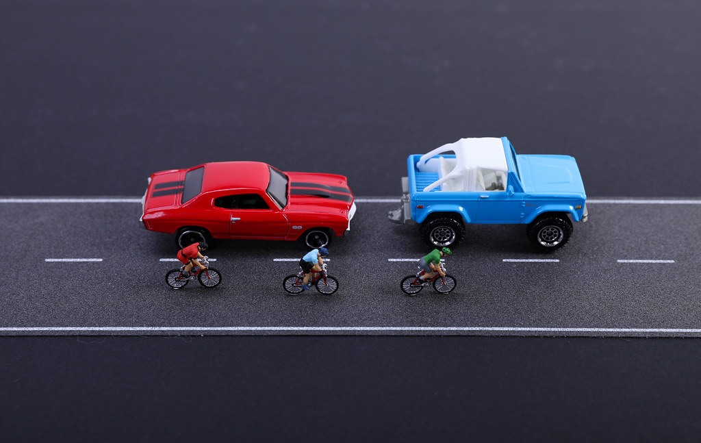 Two cars and cyclist on the road