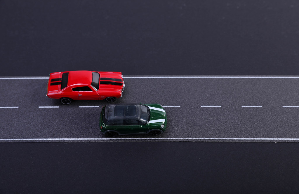 Two cars racing on the road