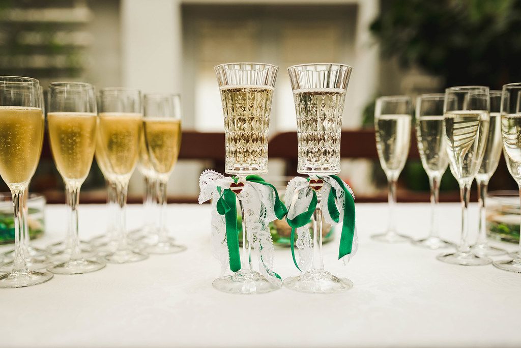 Two Champagne Glasses With Green Decor