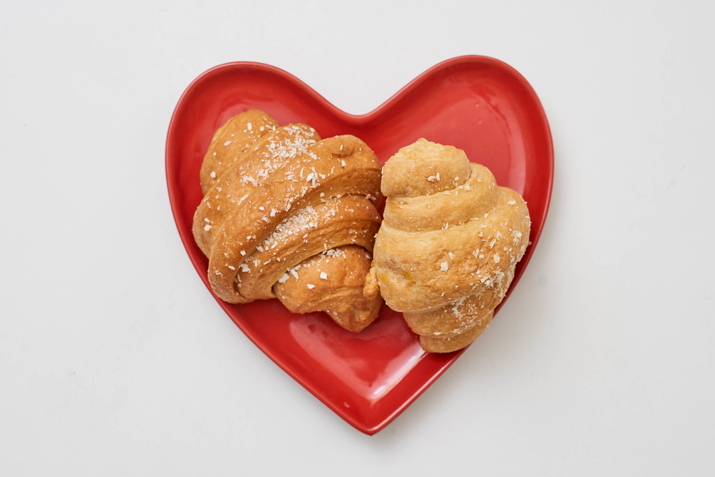 Two croissants on the heart-shaped plate