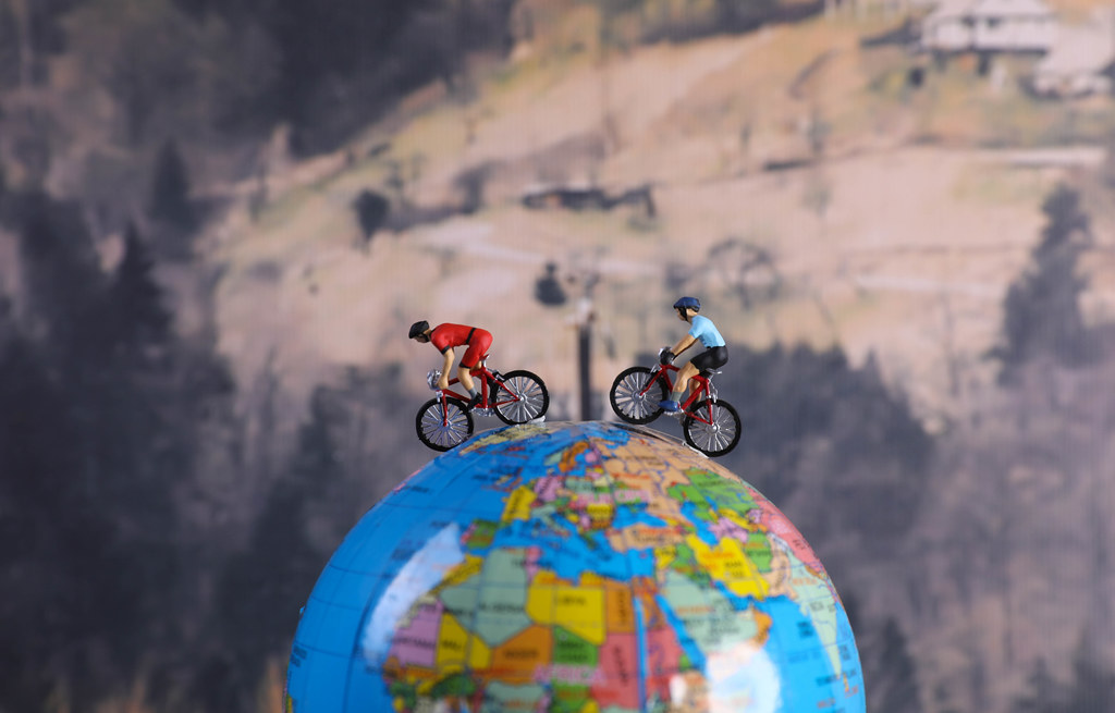 Two cyclist on the globe