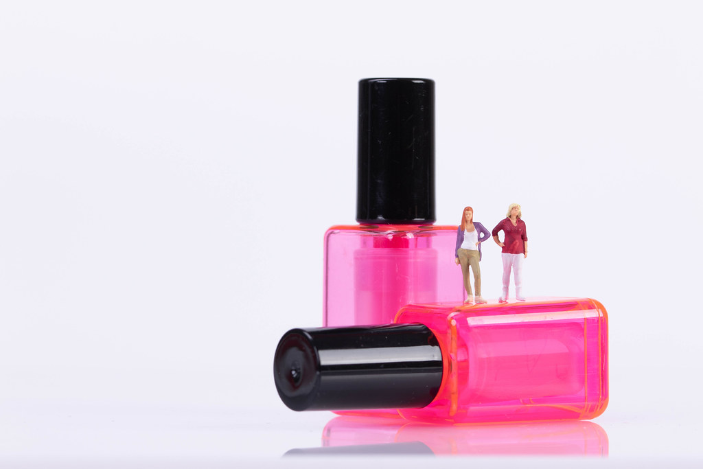 Two girls standing on nail polish