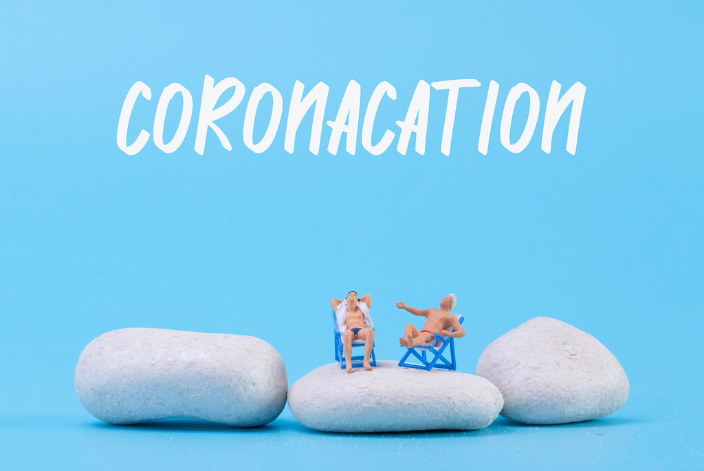 Two man relaxing in deck chairs with Coronacation text