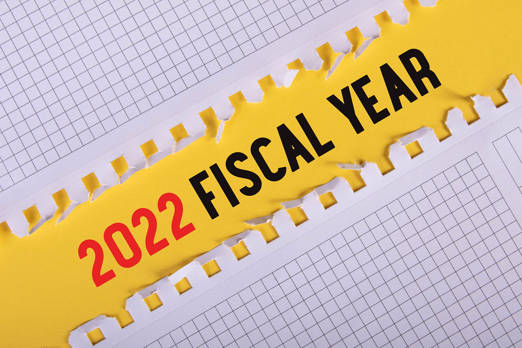 Two pieces of paper with 2022 Fiscal Year text on yellow