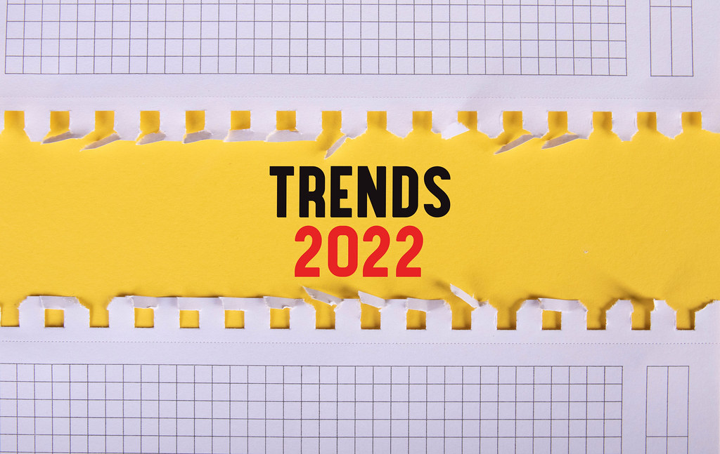 Two pieces of paper with Trends 2022 text on yellow