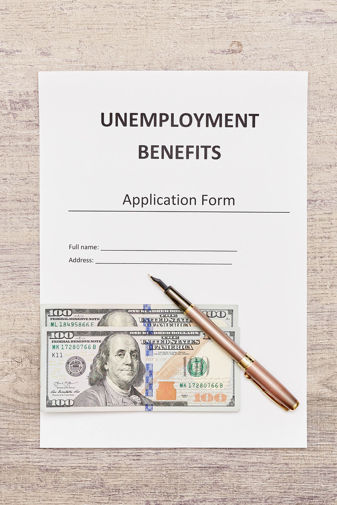 Unemployment benefits application form with us dollar bills