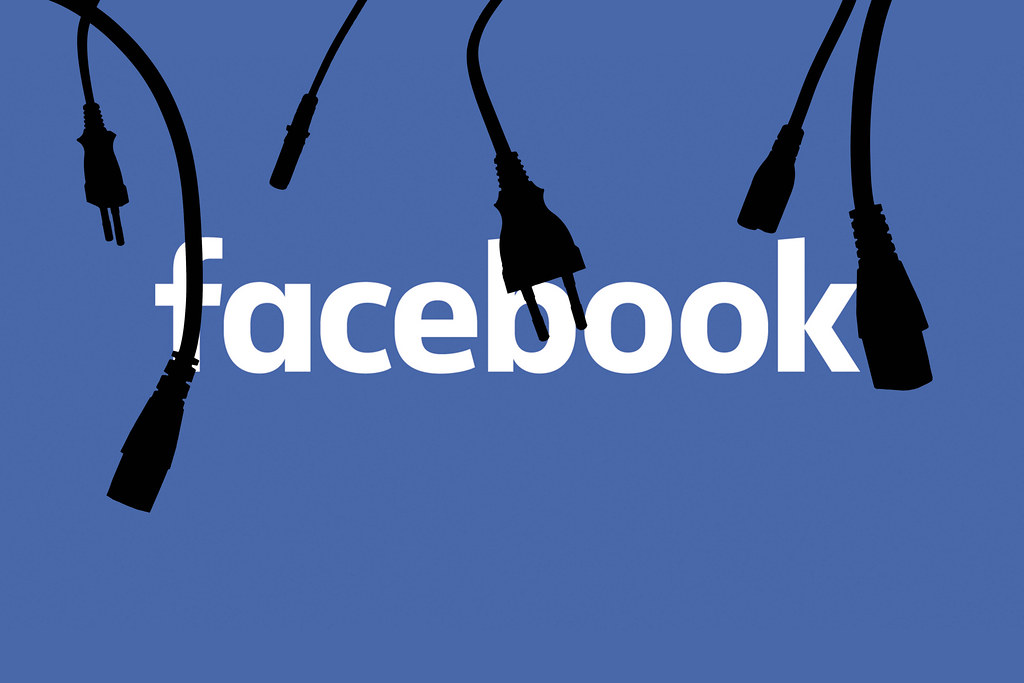 Unplugged and disconnected cables and plug silhouettes over Facebook logo. Symbol of recent global Facebook outage