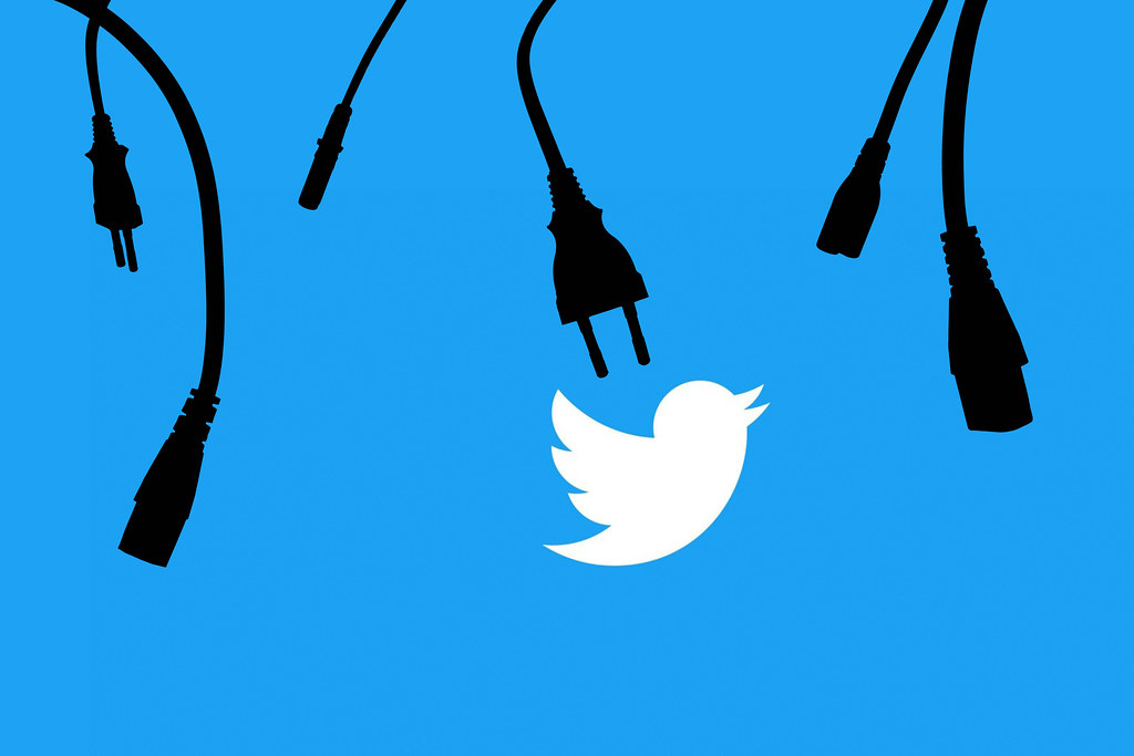 Unplugged data cables over Twitter logo. Symbol of Twitter crash