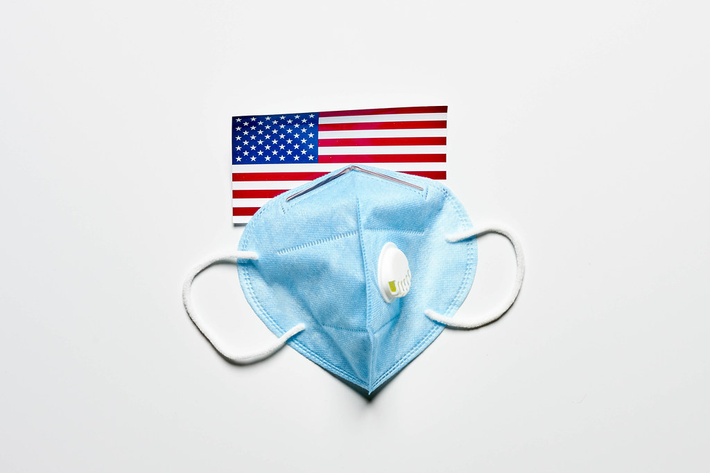 US flag and n95 face mask on white background