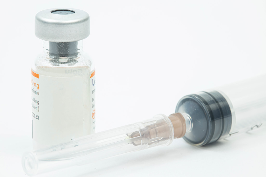 Vaccine bottle with injection needle