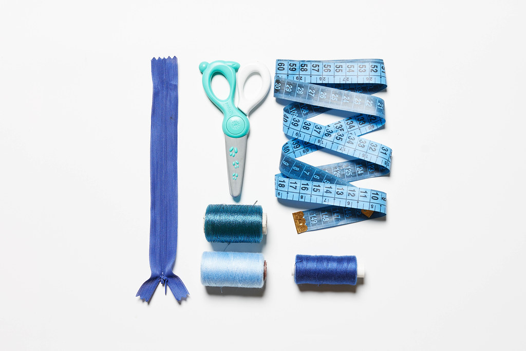 Various sewing accessories and tools in blue shades