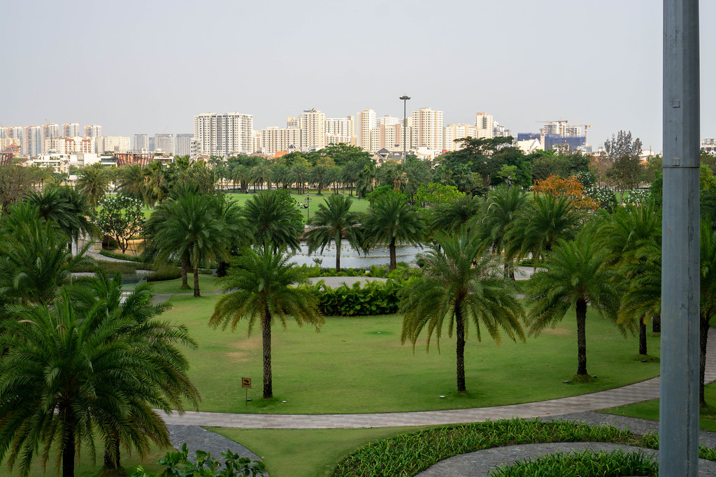 Vinhomes Central Park with many Palm Trees, a Lake and Walkways in Binh Thanh District of Ho Chi Minh City, Vietnam