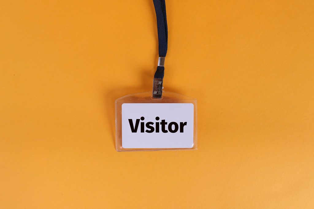 Visitor badge on orange background