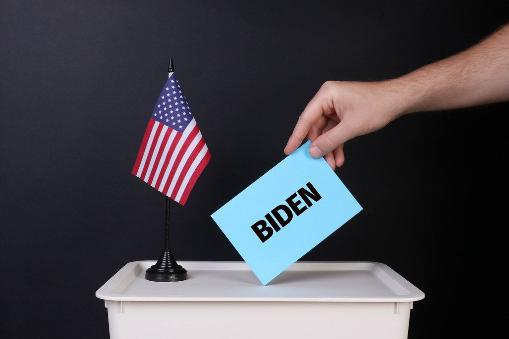 Voter holds blue envelope with Biden text
