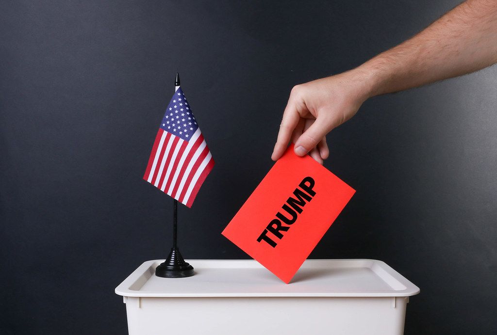 Voter holds red envelope with Trump text