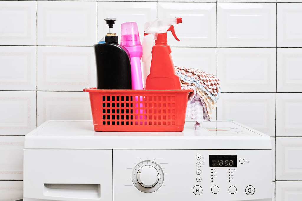 Washing machine and laundry detergent bottles in a basket